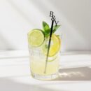 Custom personalized wedding drink stirrer in cocktail glass with lemon and mint
