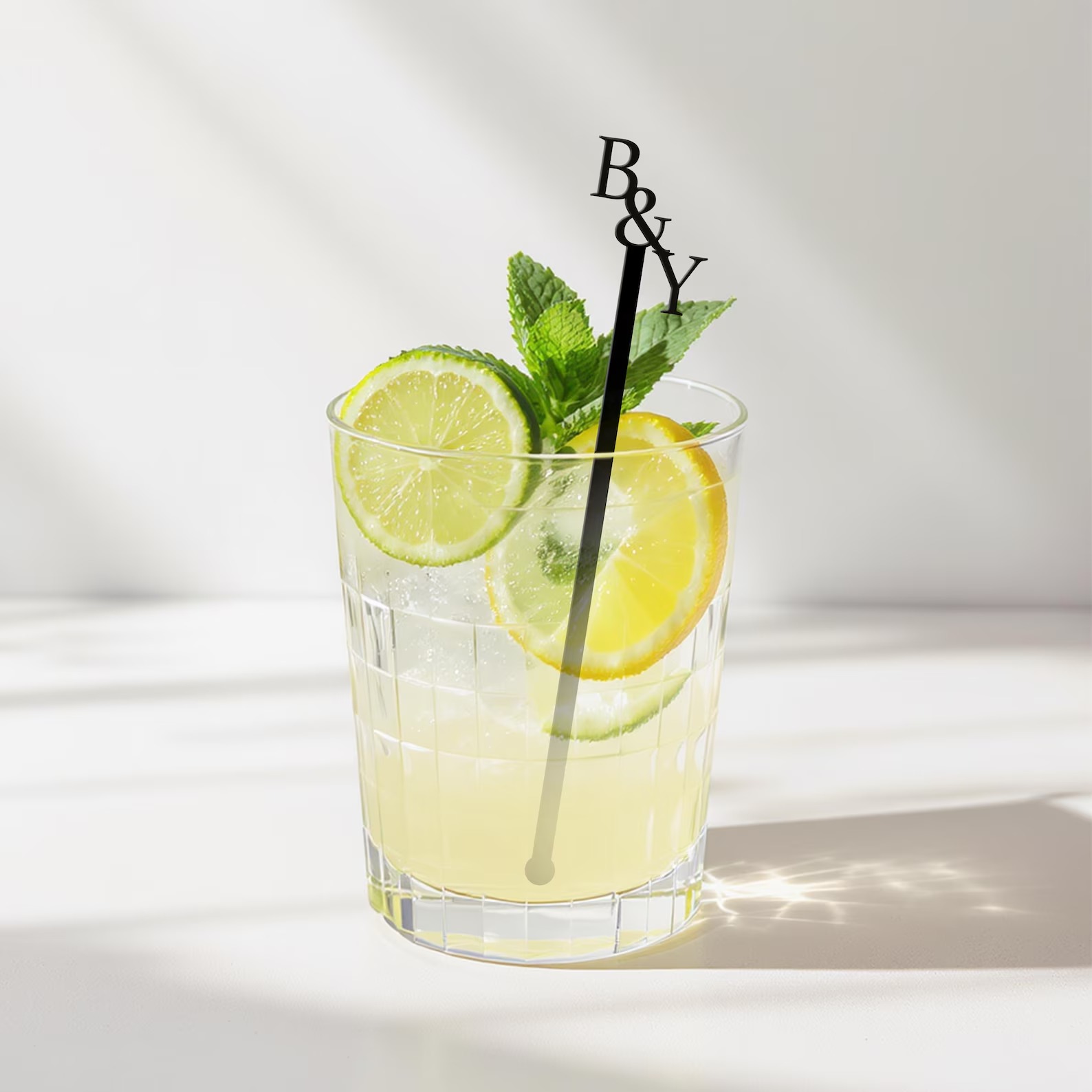 Custom personalized wedding drink stirrer in cocktail glass with lemon and mint