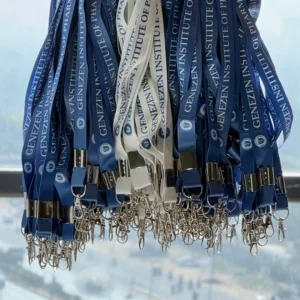 Blue customized logo lanyards with metal clips hanging in bulk for corporate distribution.