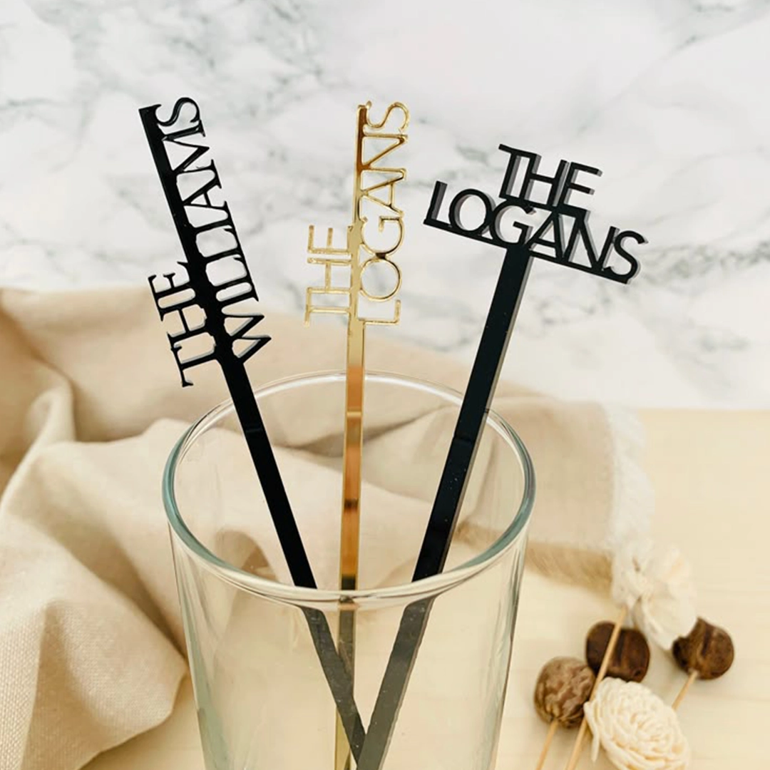 Custom family name drink stirrers reading The Williams and The Logans