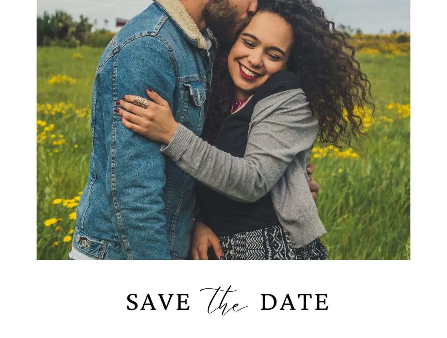 Happy couple hugging in a field